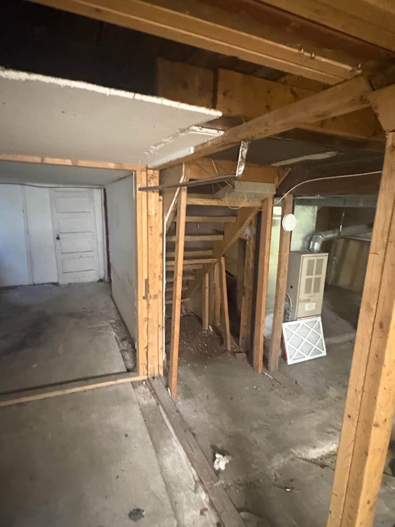 Basement framing exposed during a gut-out